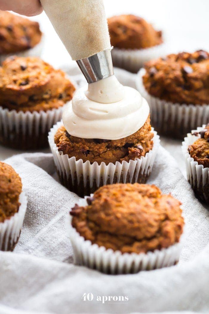 These paleo pumpkin chocolate chip muffins with cream cheese frosting are the perfect paleo fall recipe or paleo pumpkin recipe! They're moist and tender, loaded with pumpkin purée, dairy-free chocolate chips, and topped with a tangy but sweet frosting. And yep, they're entirely paleo. These paleo pumpkin chocolate chip muffins with cream cheese frosting are actually easy to make, too, so they'll become your very favorite paleo fall recipe or paleo pumpkin recipe for sure!