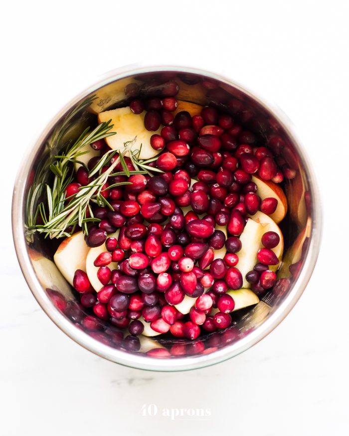 This Instant Pot Whole30 cranberry sauce with apples and rosemary is the perfect Whole30 cranberry sauce: sweet and tart with no added sweeteners at all! It's the perfect addition to any Whole30 Thanksgiving table and goes beautifully with my Whole30 green bean casserole. You'll love this Instant Pot Whole30 cranberry sauce with apples and rosemary because it's so easy and quick yet gourmet!