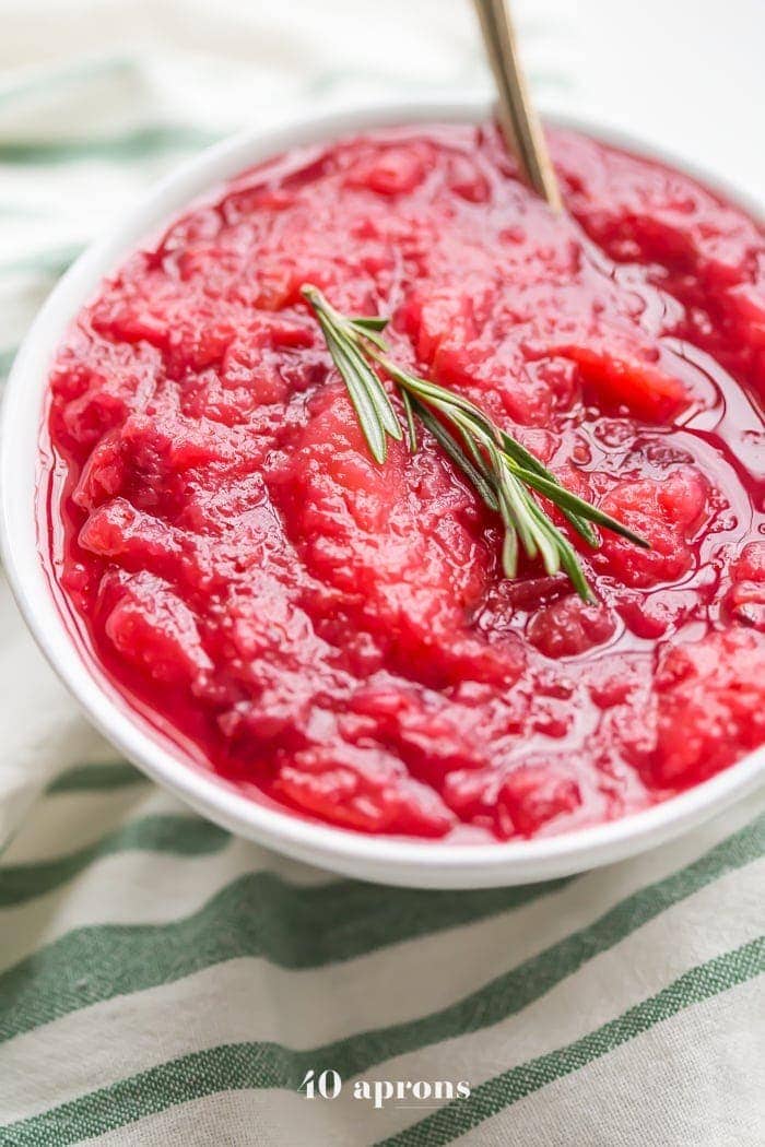 This Instant Pot Whole30 cranberry sauce with apples and rosemary is the perfect Whole30 cranberry sauce: sweet and tart with no added sweeteners at all! It's the perfect addition to any Whole30 Thanksgiving table and goes beautifully with my Whole30 green bean casserole. You'll love this Instant Pot Whole30 cranberry sauce with apples and rosemary because it's so easy and quick yet gourmet!