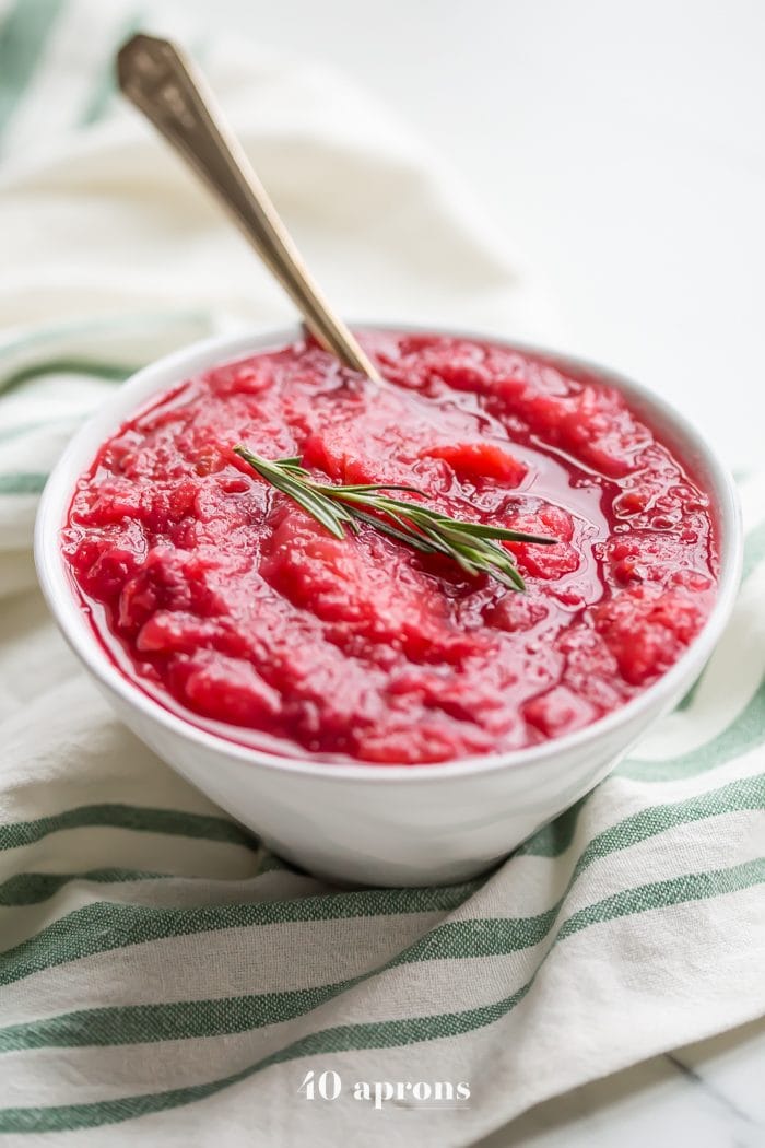 This Instant Pot Whole30 cranberry sauce with apples and rosemary is the perfect Whole30 cranberry sauce: sweet and tart with no added sweeteners at all! It's the perfect addition to any Whole30 Thanksgiving table and goes beautifully with my Whole30 green bean casserole. You'll love this Instant Pot Whole30 cranberry sauce with apples and rosemary because it's so easy and quick yet gourmet!