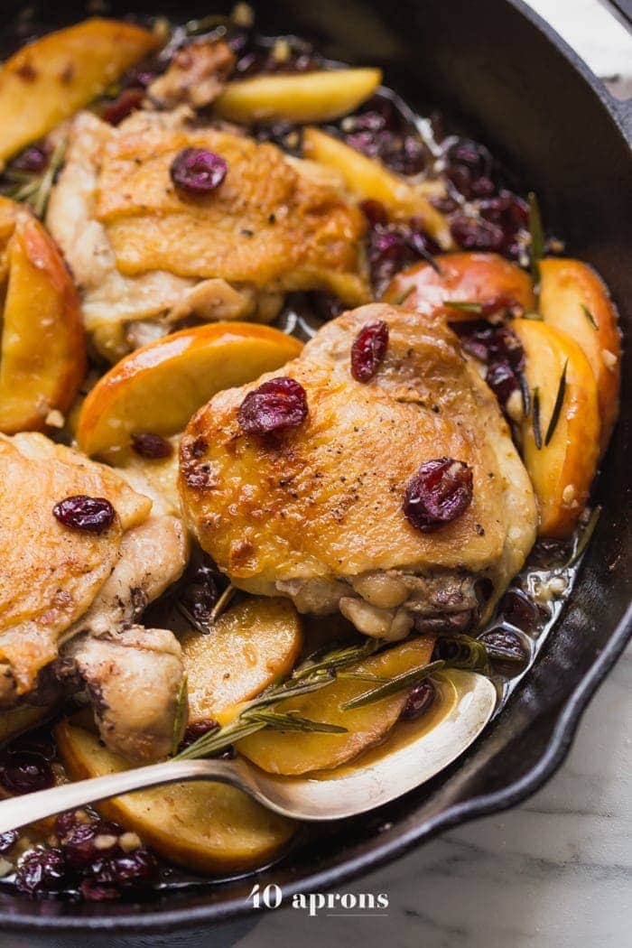 These paleo cranberry apple chicken thighs with rosemary are such a delicious paleo fall recipe. With organic cranberry juice and dried cranberries, these paleo cranberry apple chicken thighs are an easy and quick paleo dinner that’s elegant enough for company.