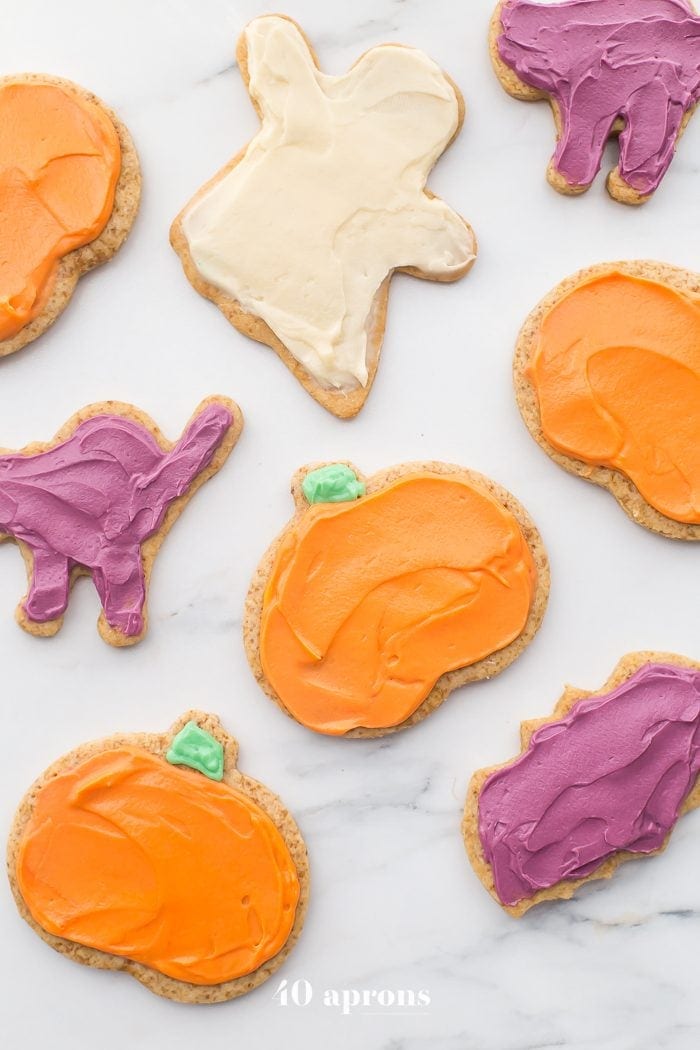 These paleo Halloween cookies are almost too cute to handle. Tender and soft with a paleo buttercream-style frosting, these paleo Halloween cookies are a must for this holiday! Whether you cut them into pumpkins, ghosts, or bats (or maybe zombies, anyone?), these paleo Halloween cookies are a healthier way to enjoy the classic holiday treat. No tricks here!