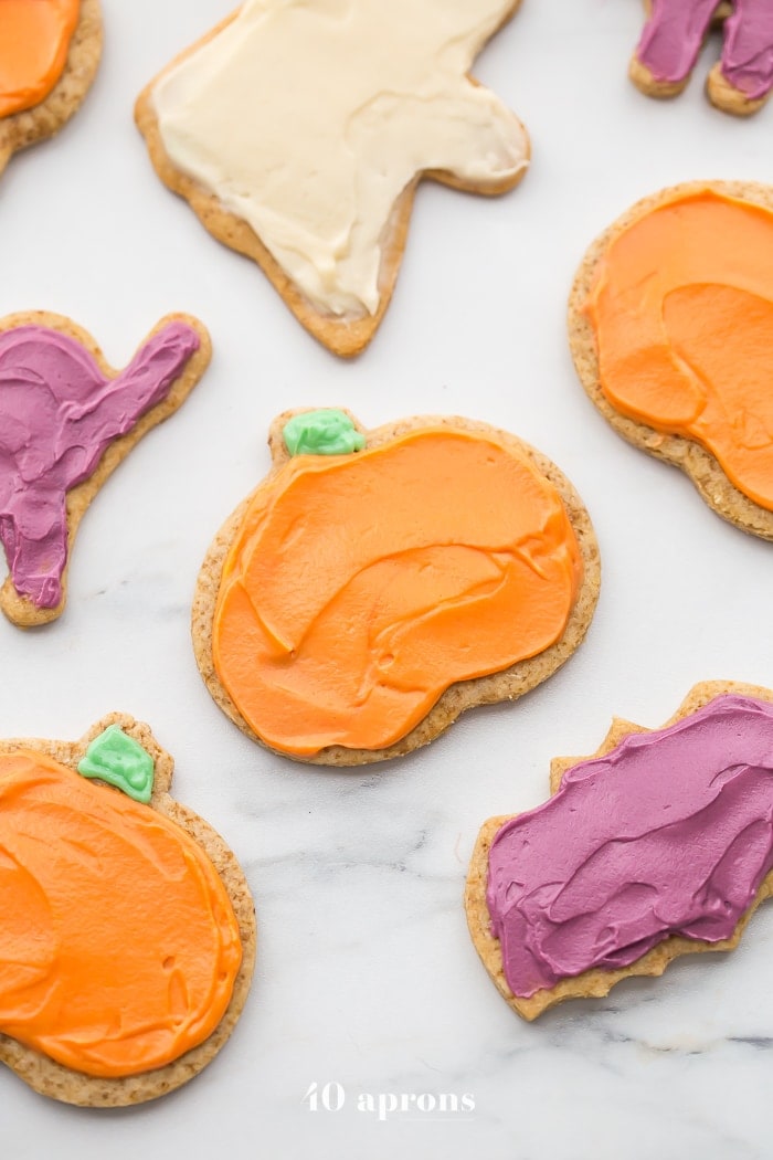 These paleo Halloween cookies are almost too cute to handle. Tender and soft with a paleo buttercream-style frosting, these paleo Halloween cookies are a must for this holiday! Whether you cut them into pumpkins, ghosts, or bats (or maybe zombies, anyone?), these paleo Halloween cookies are a healthier way to enjoy the classic holiday treat. No tricks here!