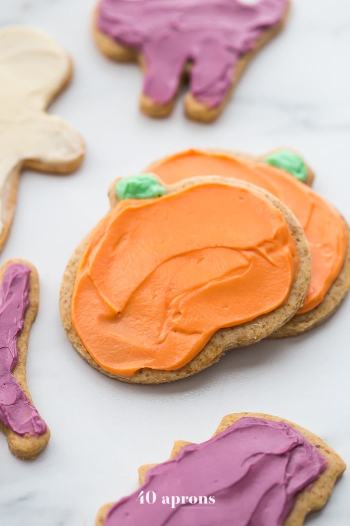 These paleo Halloween cookies are almost too cute to handle. Tender and soft with a paleo buttercream-style frosting, these paleo Halloween cookies are a must for this holiday! Whether you cut them into pumpkins, ghosts, or bats (or maybe zombies, anyone?), these paleo Halloween cookies are a healthier way to enjoy the classic holiday treat. No tricks here!