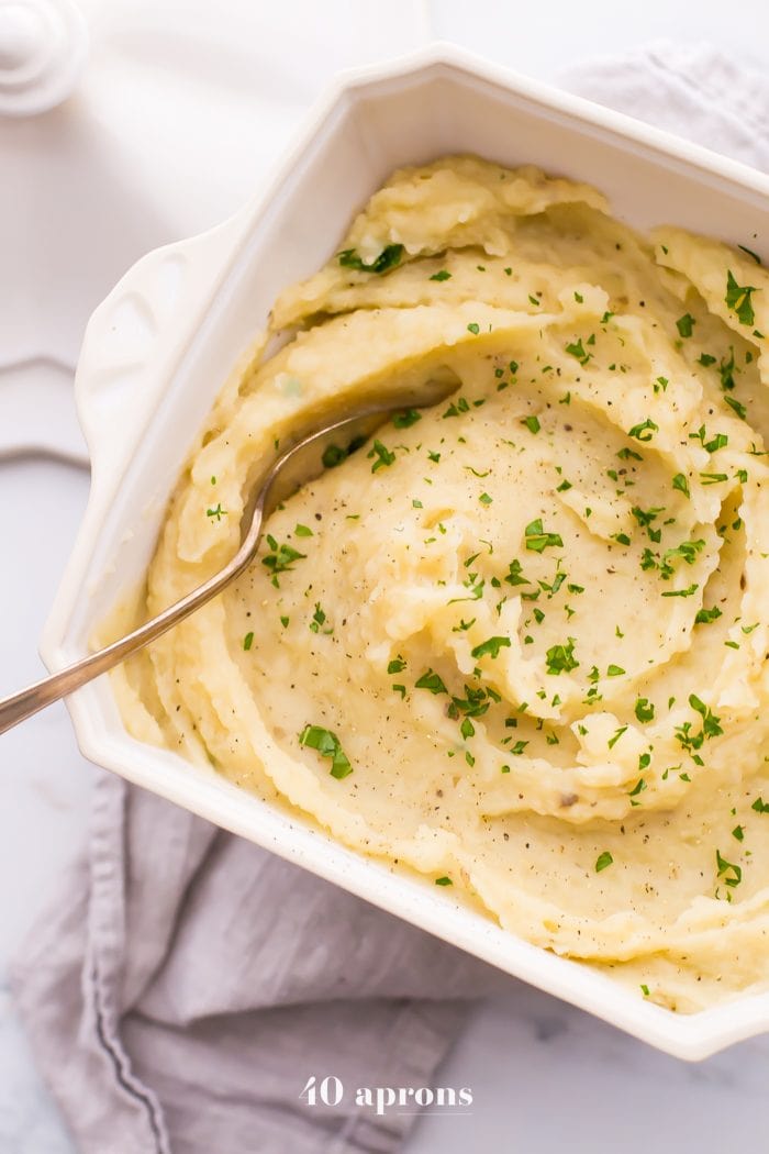 These Whole30 Crockpot mashed potatoes are so easy and creamy. Lactose-free and with a vegan or dairy-free option, these Whole30 Crockpot mashed potatoes are absolutely perfect for any Whole30 Thanksgiving or vegan Thanksgiving table, since they cook while you work on the rest of dinner! Rich and garlicky, these Whole30 Crockpot mashed potatoes will totally become a Whole30 Thanksgiving or vegan Thanksgiving tradition.