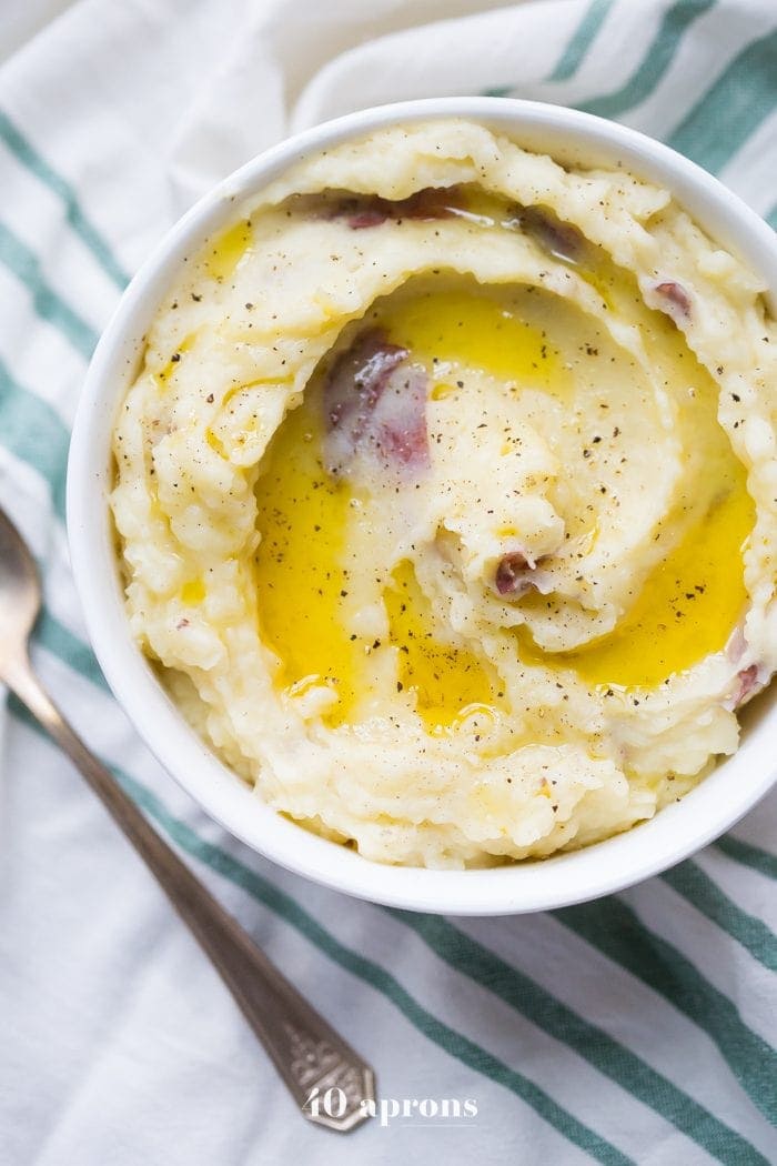 These Whole30 Instant Pot mashed potatoes with garlic and herbs are a Whole30 Thanksgiving dream: rich, creamy, garlicky, and so easy. These Whole30 Instant Pot mashed potatoes are a must for any paleo Thanksgiving table or Whole30 Thanksgiving table, and they'll become your favorite paleo Instant Pot mashed potatoes recipe for sure!