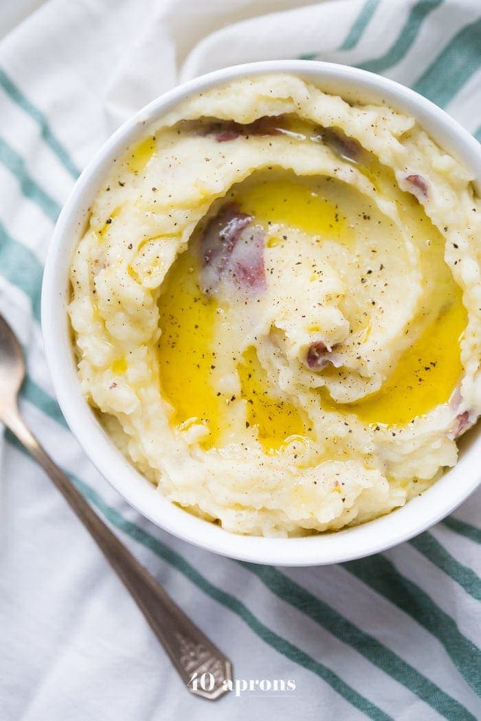 These Whole30 Instant Pot mashed potatoes with garlic and herbs are a Whole30 Thanksgiving dream: rich, creamy, garlicky, and so easy. These Whole30 Instant Pot mashed potatoes are a must for any paleo Thanksgiving table or Whole30 Thanksgiving table, and they'll become your favorite paleo Instant Pot mashed potatoes recipe for sure!