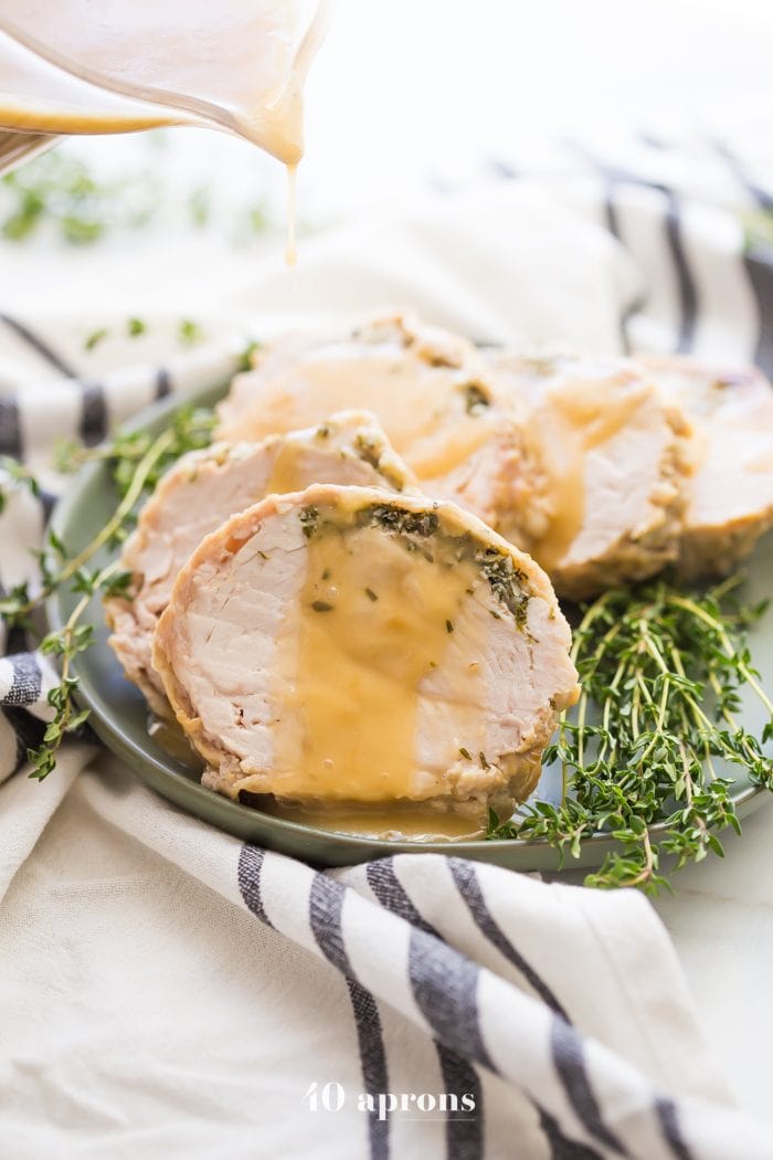 This Whole30 Instant Pot turkey breast with gravy is quick, so delicious, and totally Whole30 compliant. Brined with a garlic-herb butter under the skin, this Whole30 turkey breast and the gravy are both made in the Instant Pot, making Thanksgiving easier! You'll love this Whole30 Instant Pot turkey breast and gravy, because the meat is so tender, and the gravy is so easy. Perfect for any Whole30 Thanksgiving or paleo Thanksgiving table. 