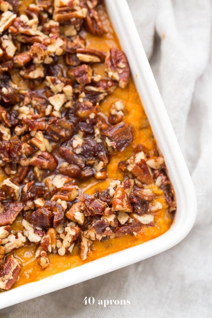 This Whole30 sweet potato casserole with pecans is a must for any Whole30 Thanksgiving table! With no sweeteners and a cinnamon pecan-date topping, you might end up eating the leftovers for breakfast (we did!). This Whole30 sweet potato casserole is naturally sweetened and just so delicious. A new Whole30 Thanksgiving classic! 