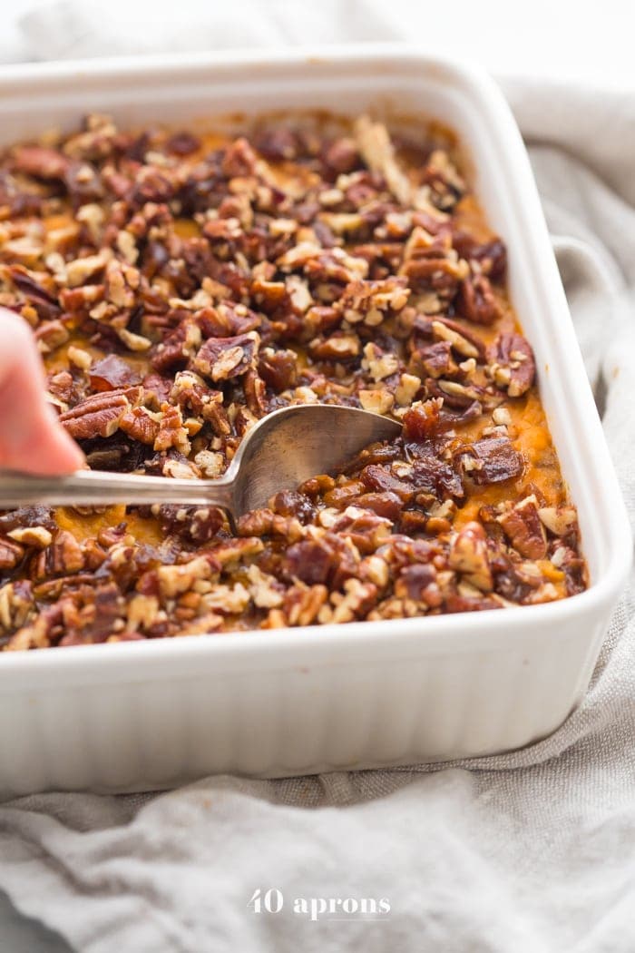 This Whole30 sweet potato casserole with pecans is a must for any Whole30 Thanksgiving table! With no sweeteners and a cinnamon pecan-date topping, you might end up eating the leftovers for breakfast (we did!). This Whole30 sweet potato casserole is naturally sweetened and just so delicious. A new Whole30 Thanksgiving classic! 