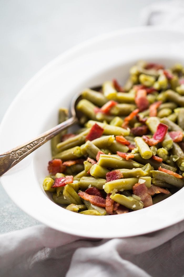 Whole30 Del Monte green beans with bacon in a white dish