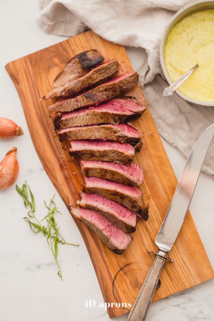 Medium-rare Whole30 steak with Whole30 béarnaise sauce in a dish