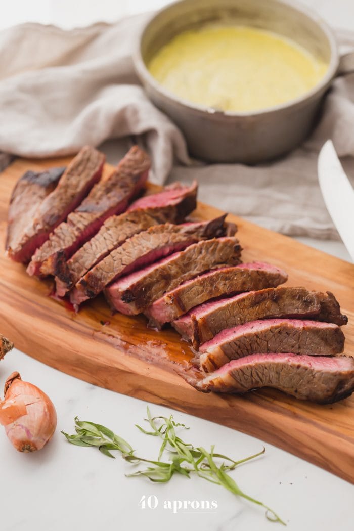 Medium-rare Whole30 steak with Whole30 béarnaise sauce in a dish