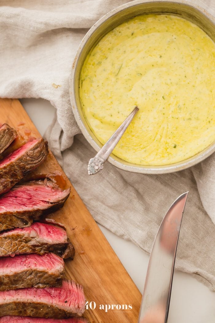 Medium-rare Whole30 steak with Whole30 béarnaise sauce in a dish