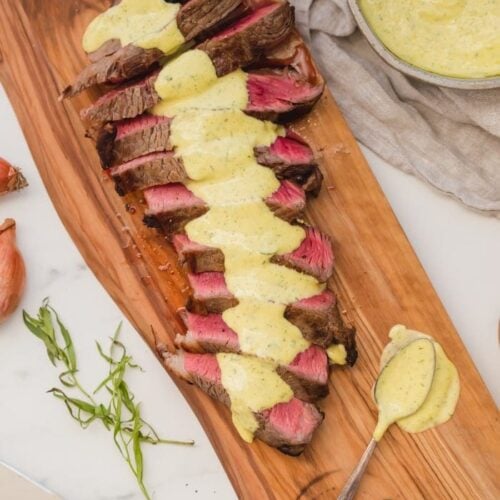 Medium-rare Whole30 steak with Whole30 béarnaise sauce in a dish