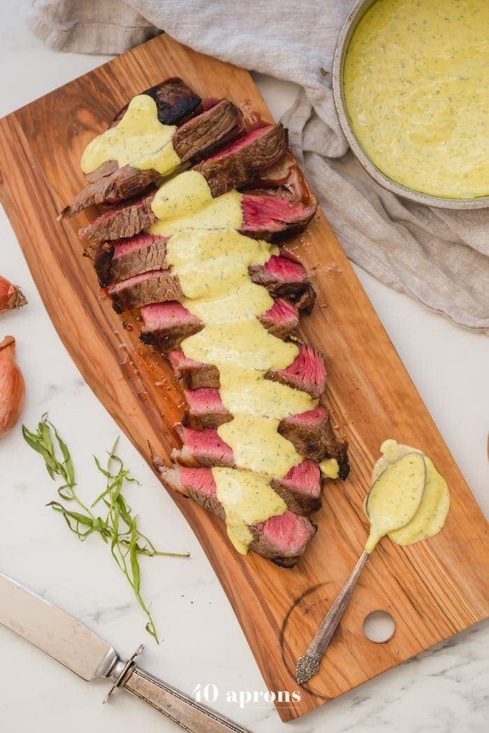 Medium-rare Whole30 steak with Whole30 béarnaise sauce in a dish