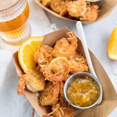 Whole30 coconut shrimp with orange sauce in a container