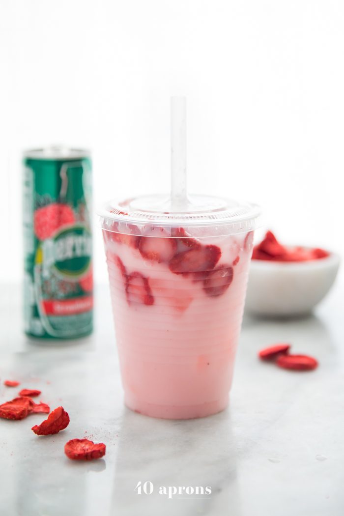 Healthy pink drink strawberry refresher with freeze dried strawberries, Perrier strawberry sparkling water, and coconut milk