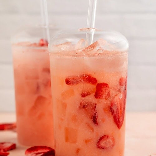 A Starbucks pink drink copycat in a glass on a table.