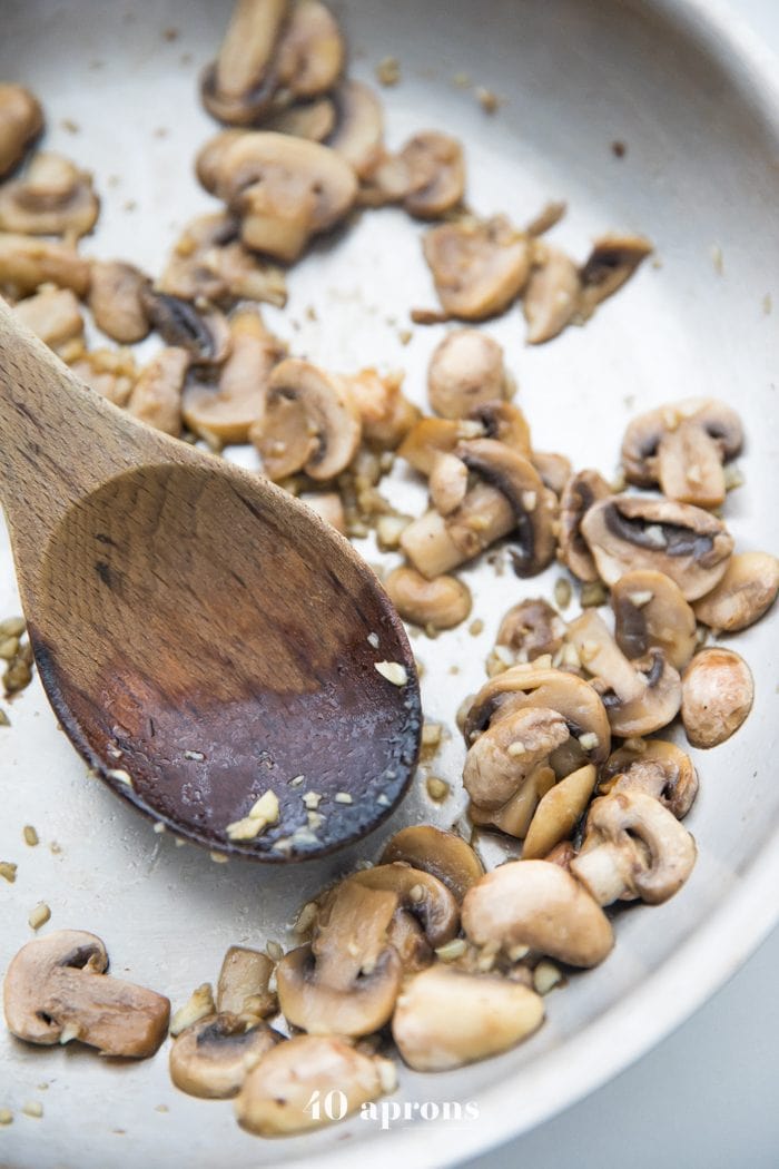 Sautéed mushrooms in a pan for Whole30 tuna zoodle casserole