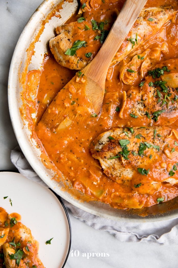 Creamy tomato artichoke chicken (Whole30, paleo) in a skillet