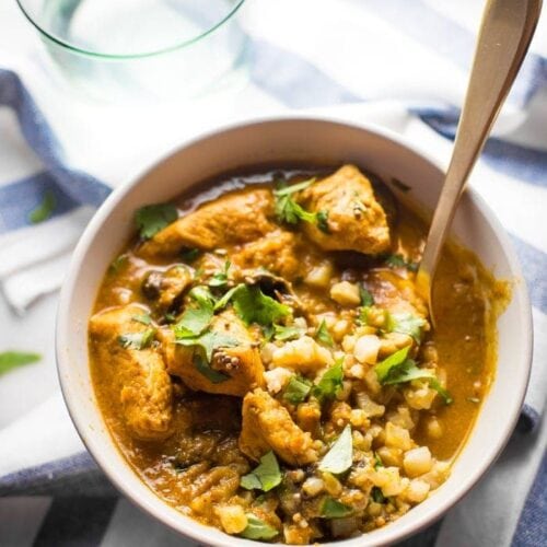 Whole30 chicken curry in a bowl with cauliflower rice