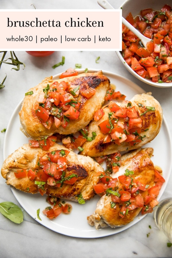 Bruschetta chicken on a plate with fresh basil, bruschetta, and more bruschetta chicken in background