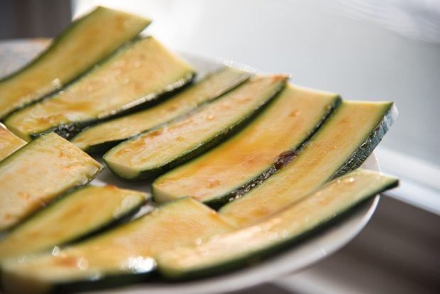 raw zucchini slices freshly glazed with orange glaze