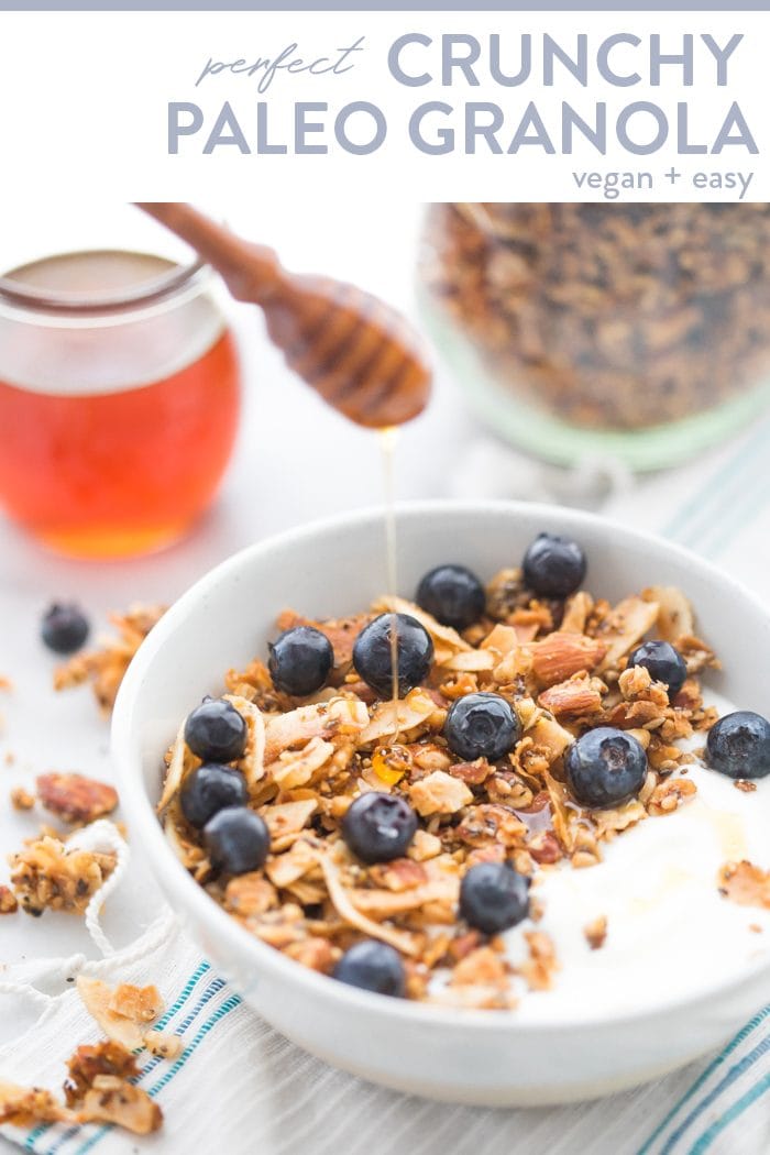 Bowl of the crunchy paleo granola recipe over yogurt, topped with blueberries and a drizzle of honey