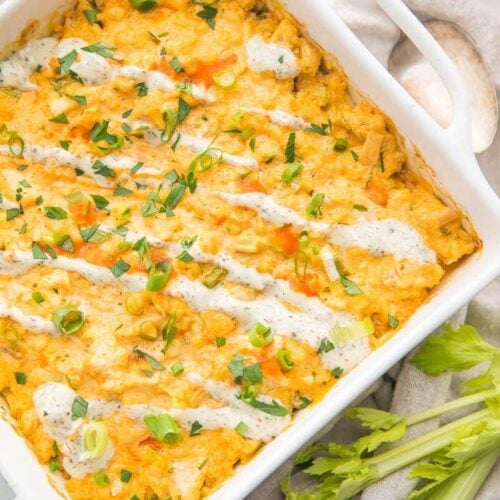 Paleo buffalo chicken casserole in a white dish with celery stalks to the side