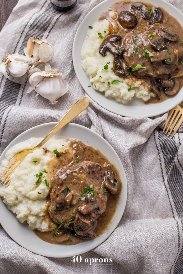 Overhead shot of Whole30 Salisbury Steak served with mashed potatoes and sprinkled with chives