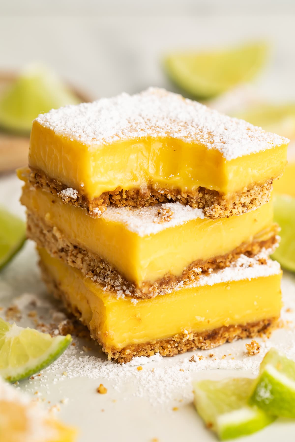 3 paleo lime bars stacked on top of each other. The top bar has a corner missing with teeth marks.