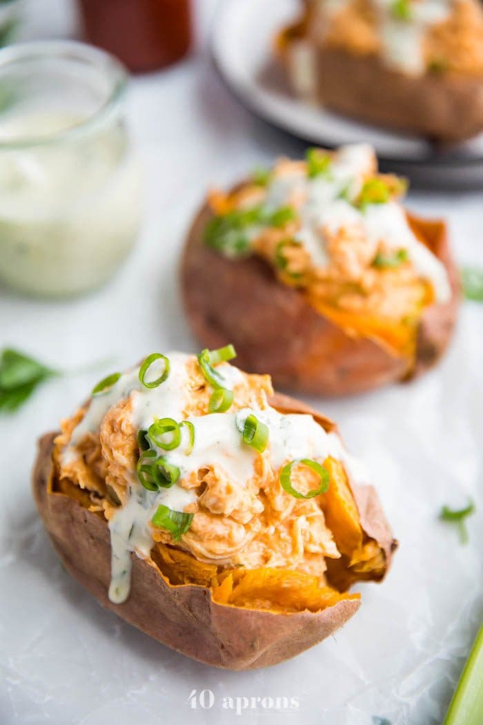 Buffalo chicken stuffed sweet potatoes with ranch and celery sticks