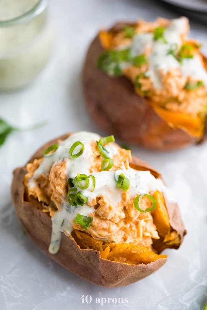 Buffalo chicken stuffed sweet potatoes with ranch and celery sticks