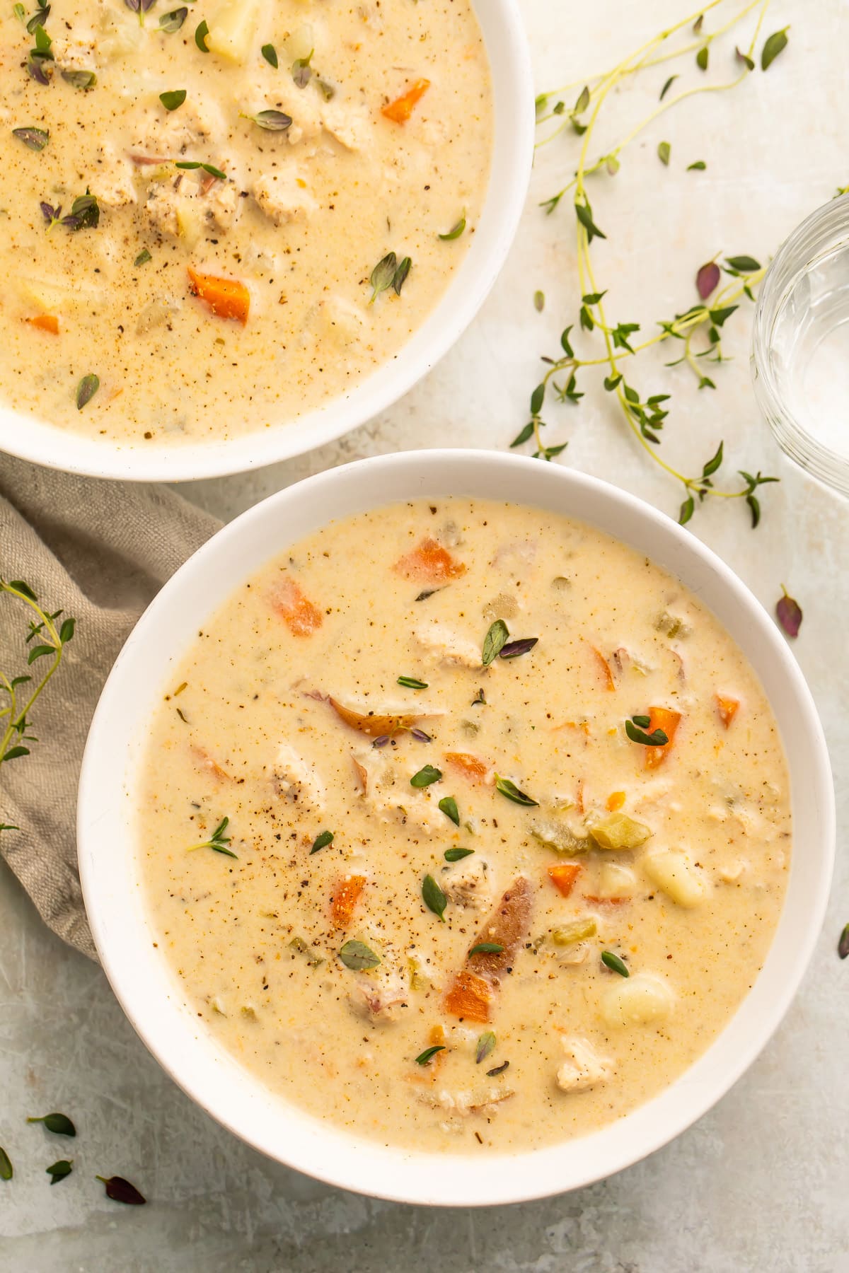 A white soup bowl, holding a creamy chicken pot pie soup made in the Instant Pot.