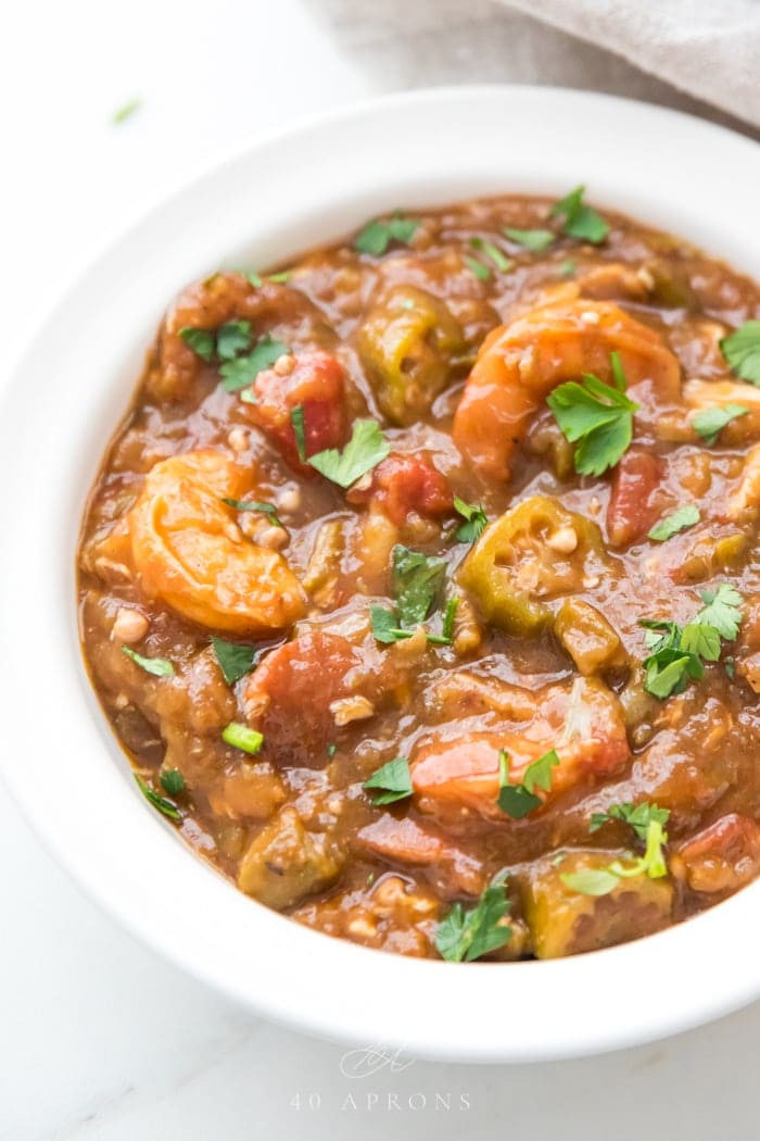 Healthy authentic seafood gumbo in a bowl with shhrimp and okra over cauliflower rice in a white bowl 