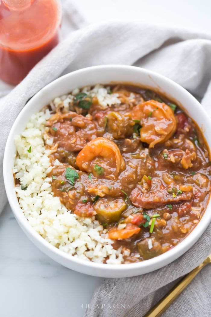 Healthy authentic seafood gumbo in a bowl with shhrimp and okra over cauliflower rice in a white bowl 