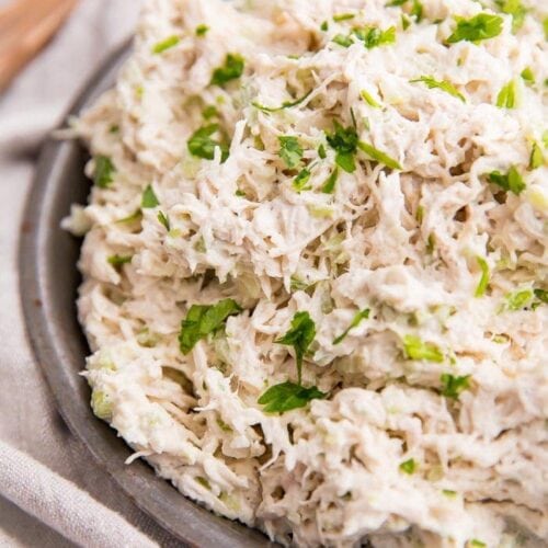 Shredded chicken salad on an antique metal bowl