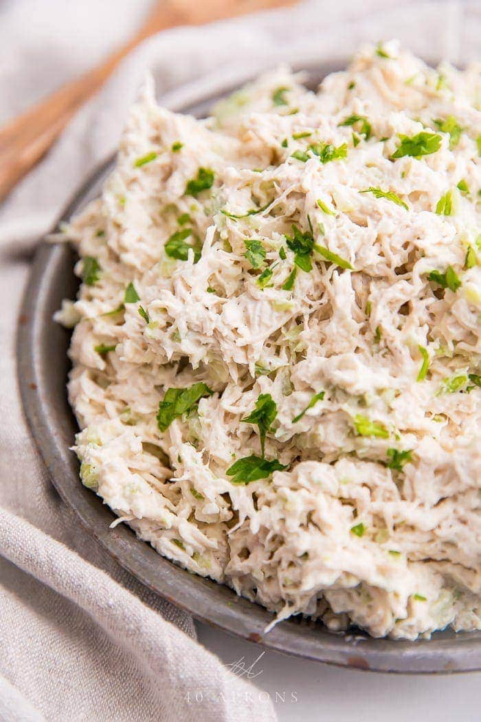 Shredded chicken salad on an antique metal bowl