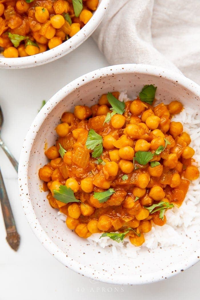 Up close bowl of chana masala over jasmine rice