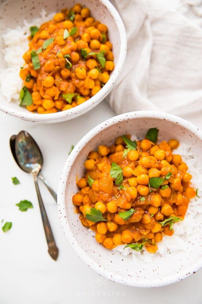 Two bowls of chana masala over basmati rice