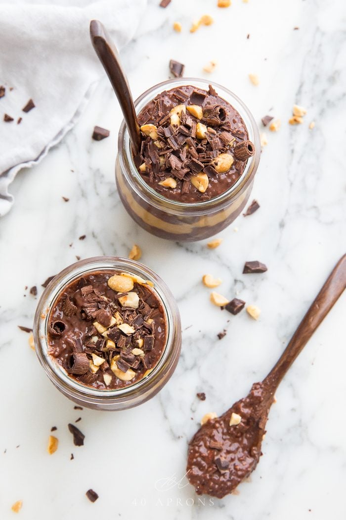 Top shot of two jars of chia pudding with a spoon next to them