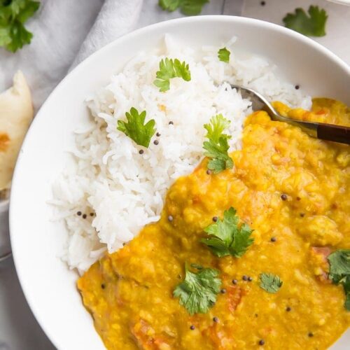 Instant Pot dal over basmati rice in a white bowl