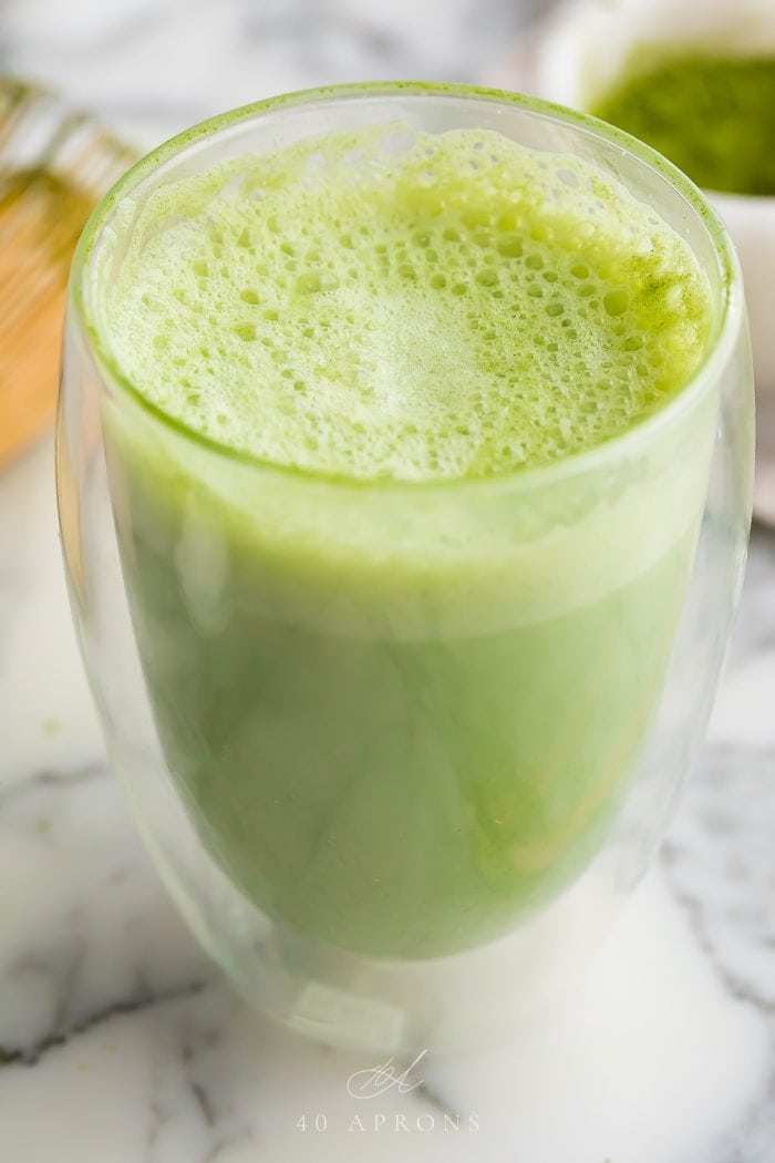 A matcha latte served in a glass mug