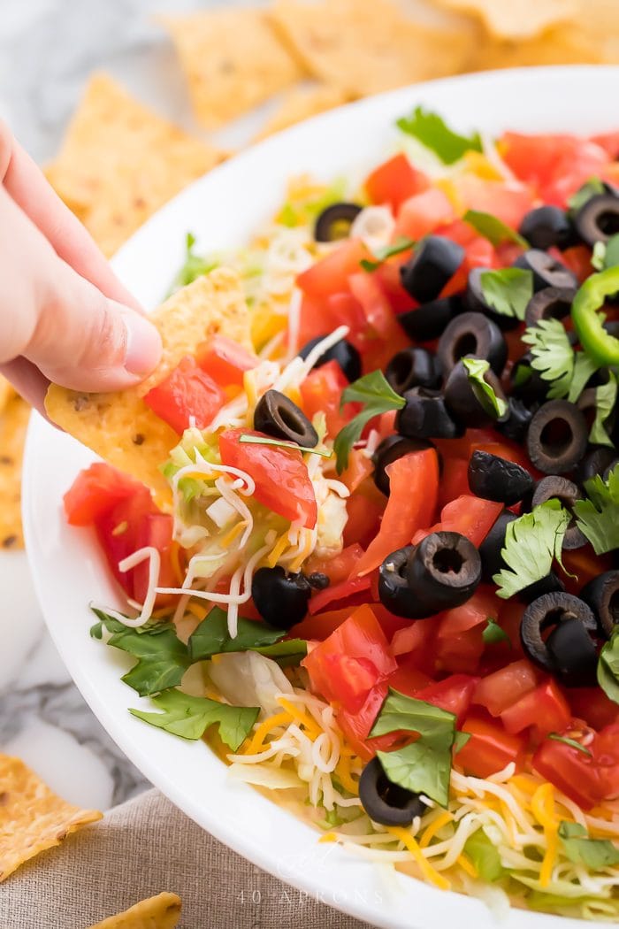 A tortilla scooping up the loaded appetizer