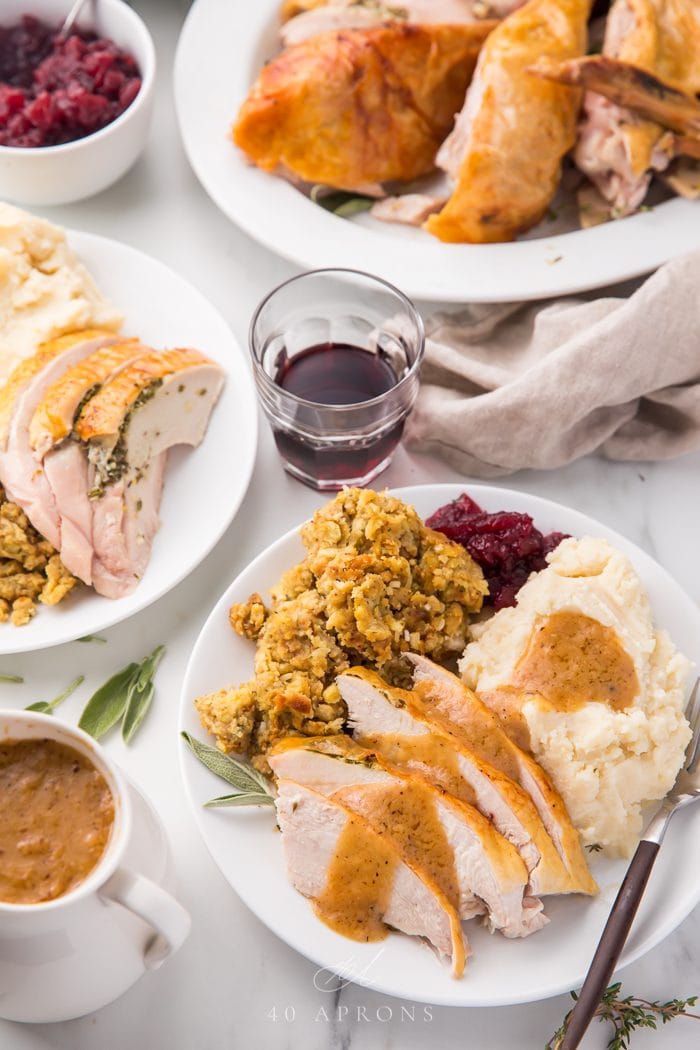 Slices of turkey served on a plate with side dishes