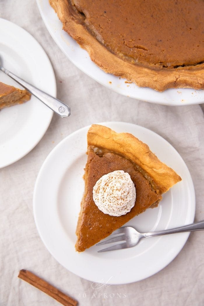 A slice of paleo pumpkin pie on a white plate