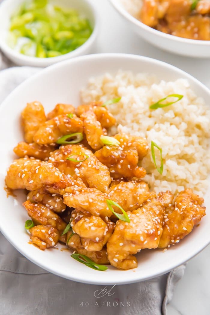 Sesame chicken served on a bed of cauliflower rice