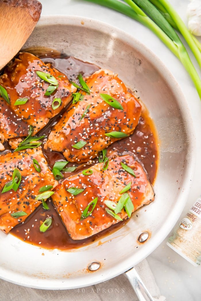 Fillets of salmon in teriyaki sauce in a white bowl