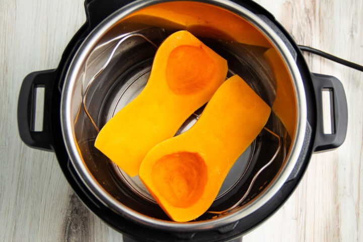 Butternut squash in Instant Pot on trivet with 1 cup water in the bottom of the pot.